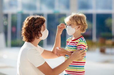 Mother and child wear facemask during coronavirus and flu outbreak.