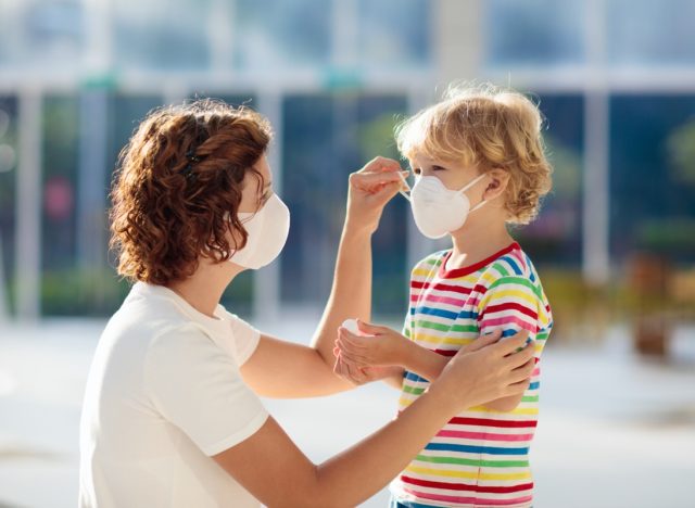 Mother and child wear facemask during coronavirus and flu outbreak.