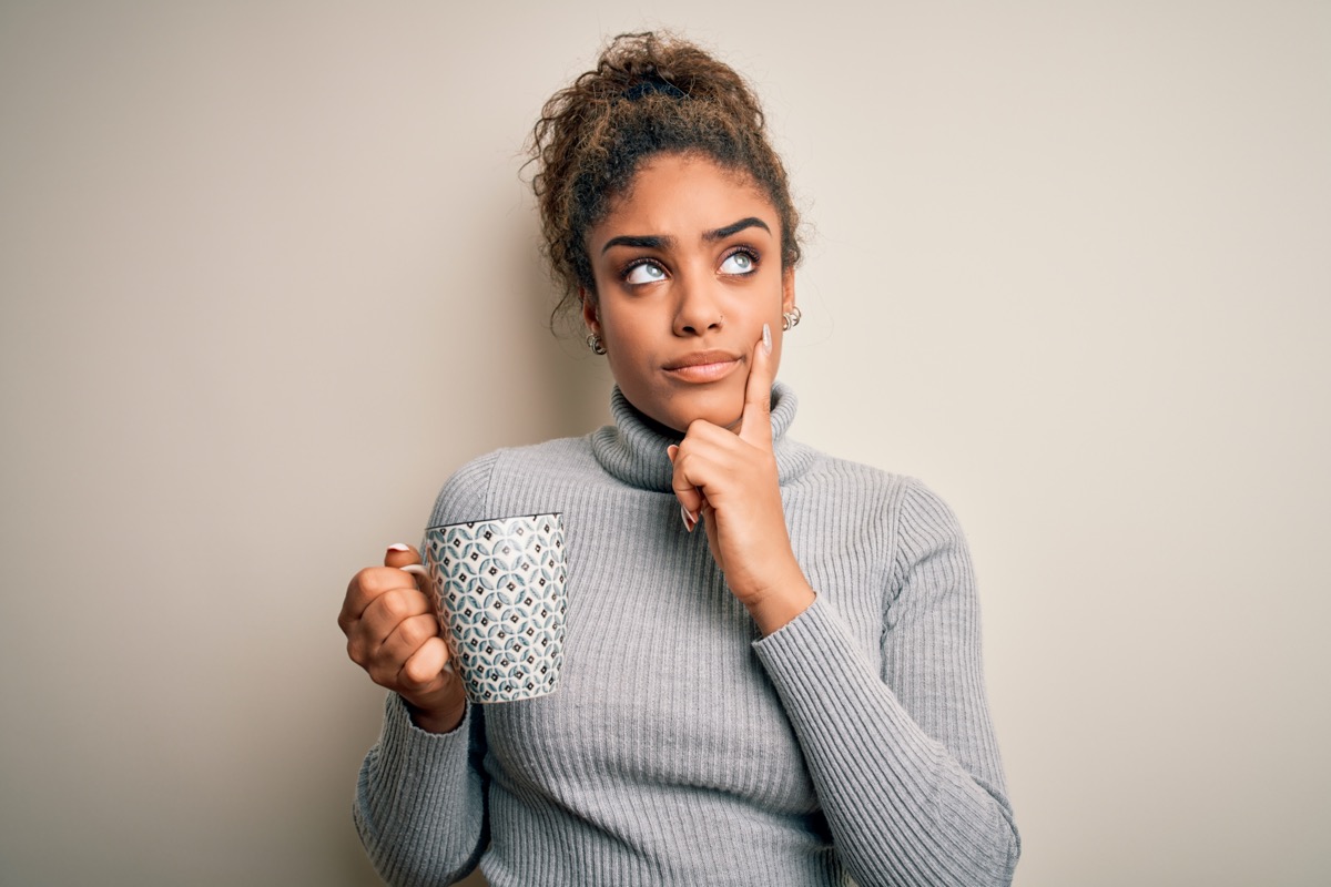 Woman wondering thinking cup