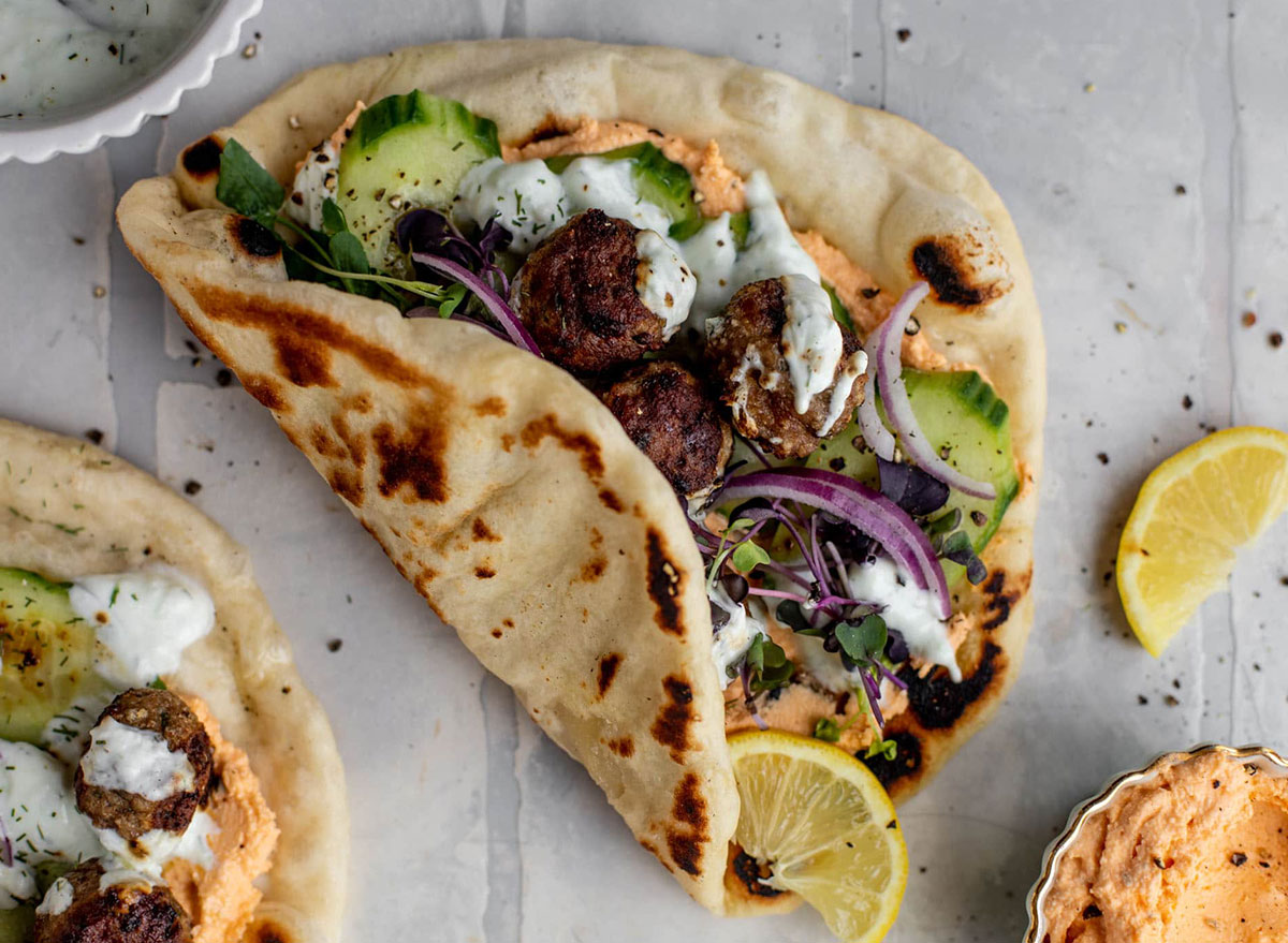 chicken meatball pita with hummus and lemon wedge