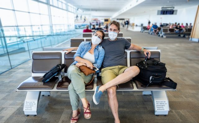 Couple with face mask stuck in airport terminal
