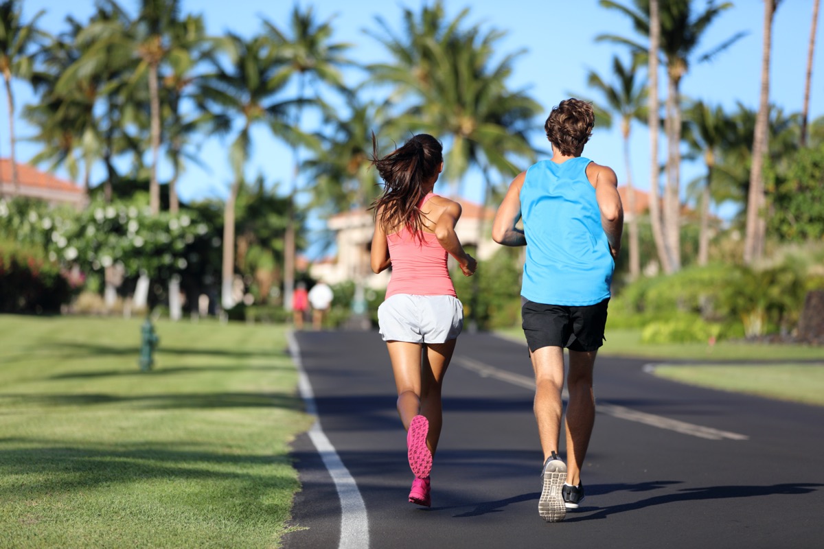 Runners athletes running training legs on road in residential neighborhood