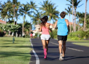 Runners athletes running training legs on road in residential neighborhood