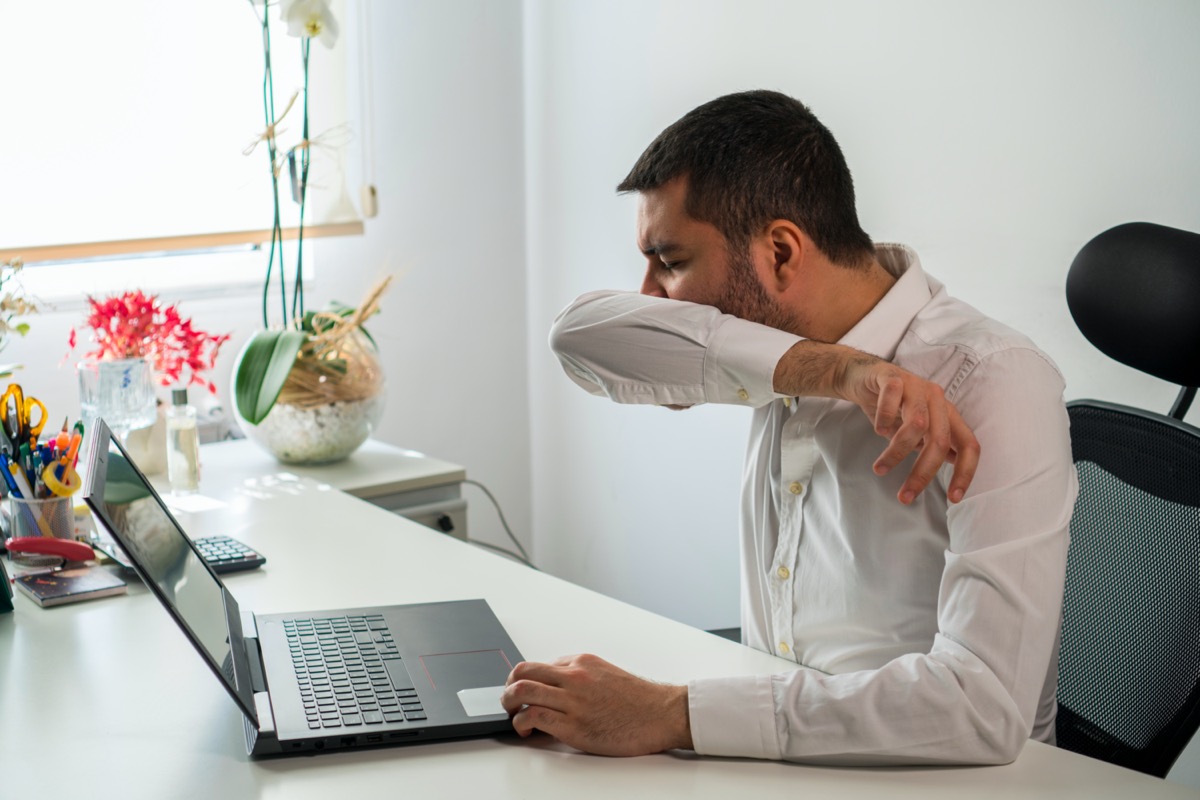 Young Business Man Sneezing. Coughing Into His Sleeve or Elbow to Prevent Spread Covid-19. Corona Virus