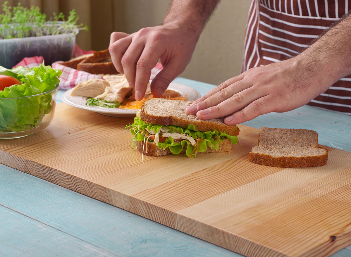 man making sandwich