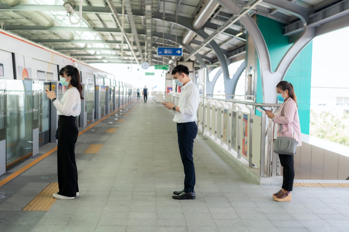 People waiting subway social distancing face mask