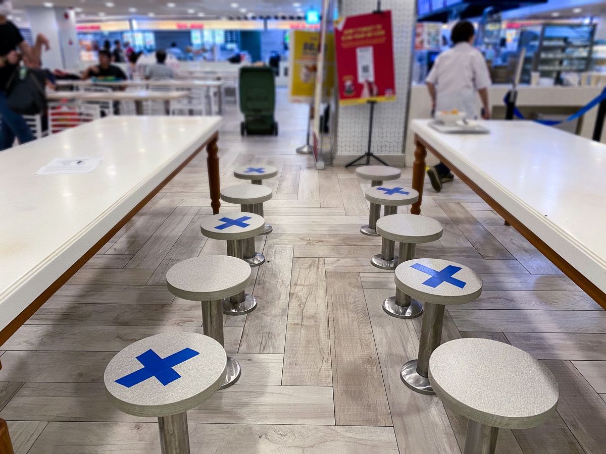 Social distancing rules in practice, alternate seating in local public food courts