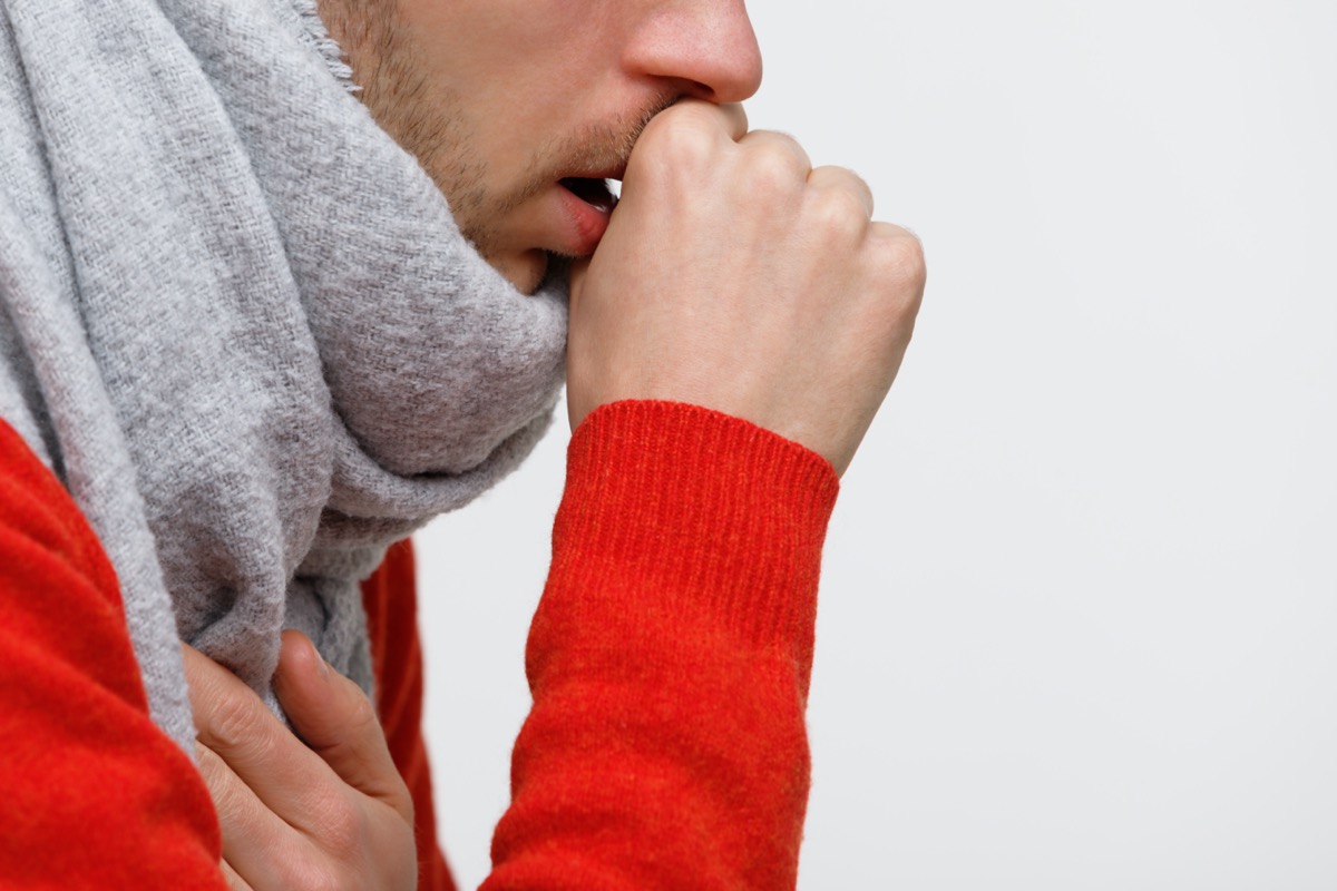 unhealthy man in orange sweater suffering with pulmonary cough