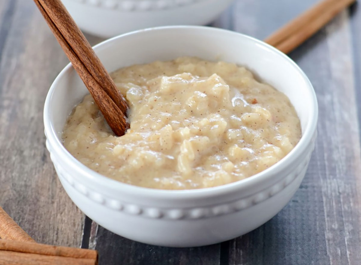 slow cooker rice pudding in bowl with cinnamon stick