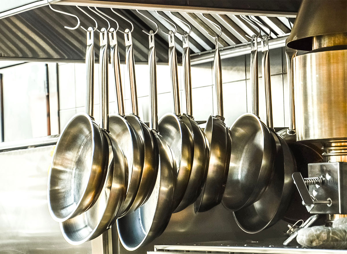 stainless steel pans on hanging rack