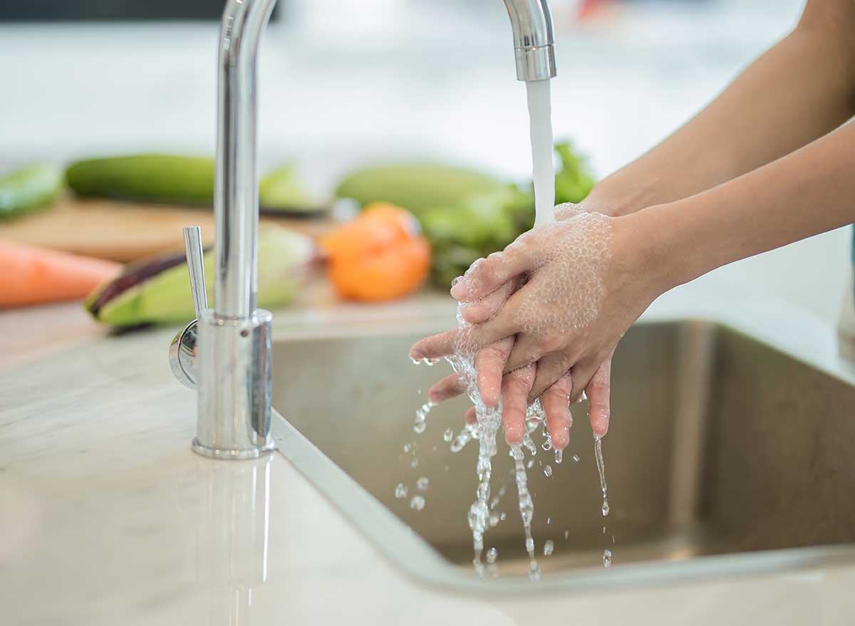 washing hands in kitchen