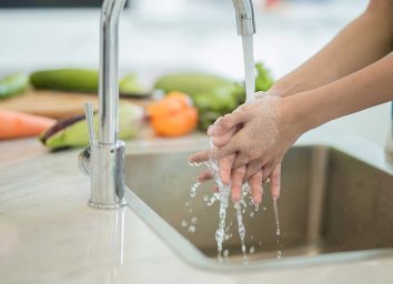 washing hands in kitchen