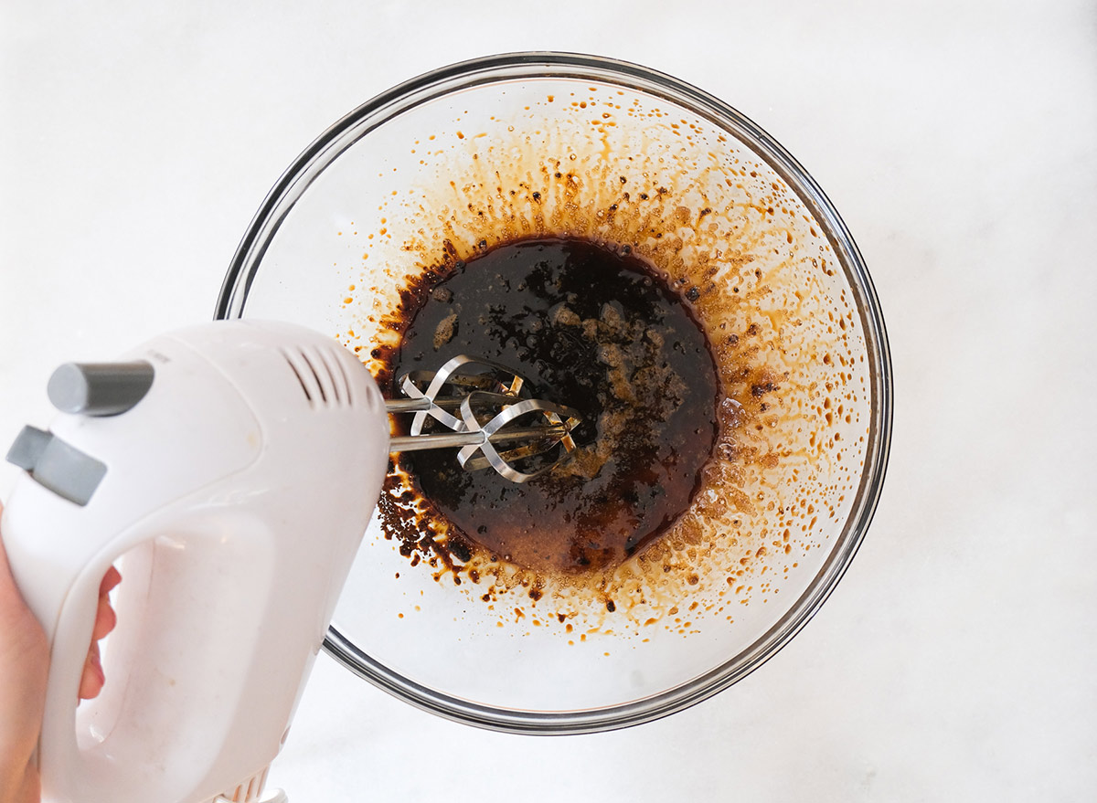 whisking coffee with sugar and water