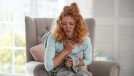 Curly woman feeling bad and suffering from strong cough while having flu