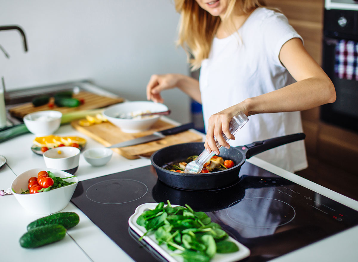 Woman cooking vegetables in the kitchen. 