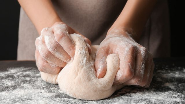 Woman kneading dough for bread