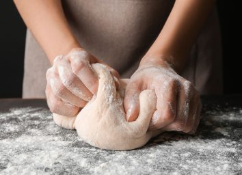Woman kneading dough for bread
