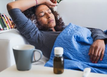 woman feeling sick and seasonal flu symptoms