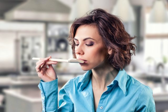 girl with a spoon near a mouth