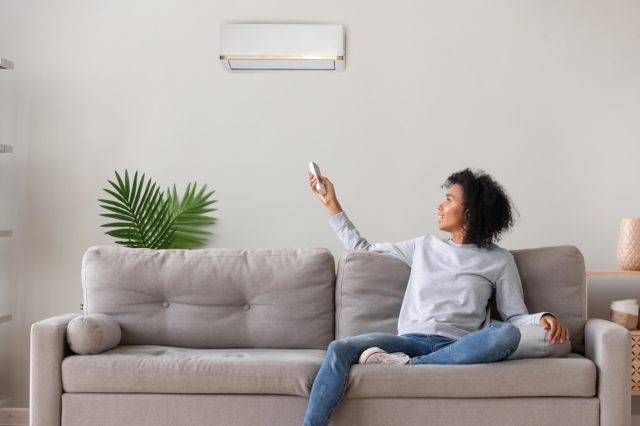 Woman using an air conditioner