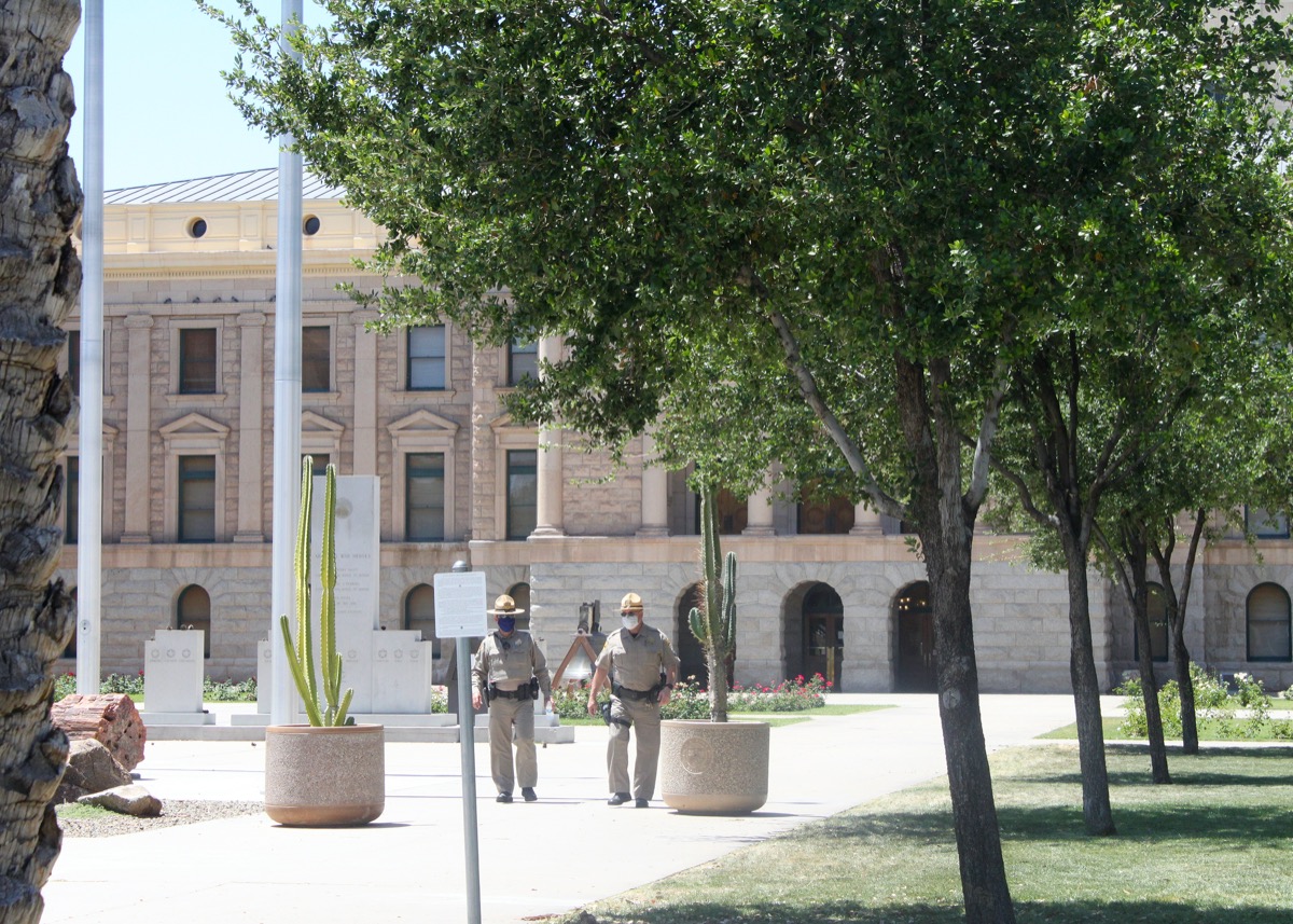 Phoenix, Ariz. / US - May 3, 2020: Wearing masks, State Capitol Police monitor Trump supporters rallying to "reopen" the economy from covid-19 safety restrictions.