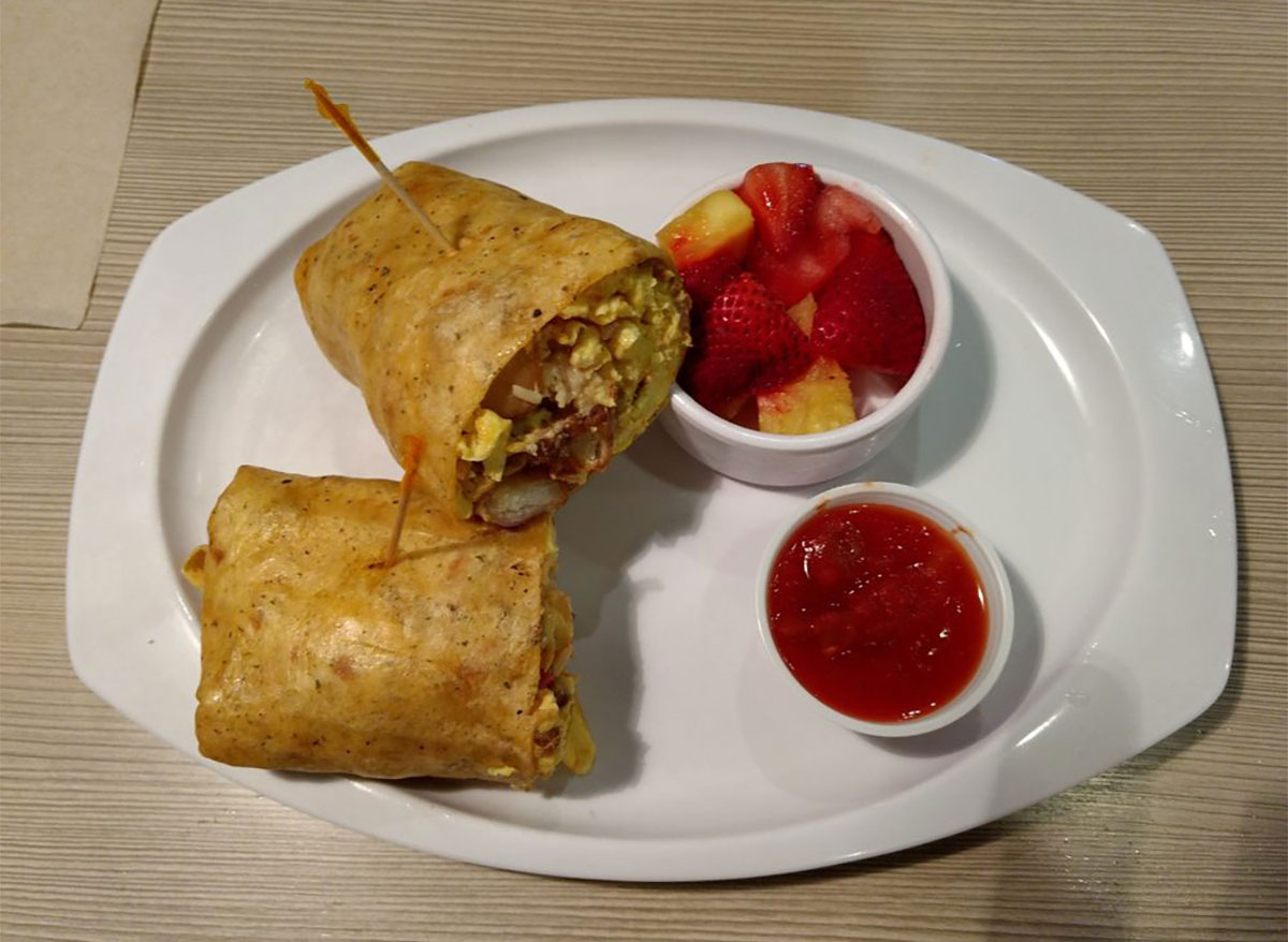breakfast burrito with fruit cup and salsa