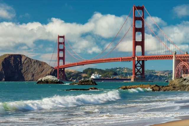Golden Gate Bridge at sunset seen from San Francisco beach, California.