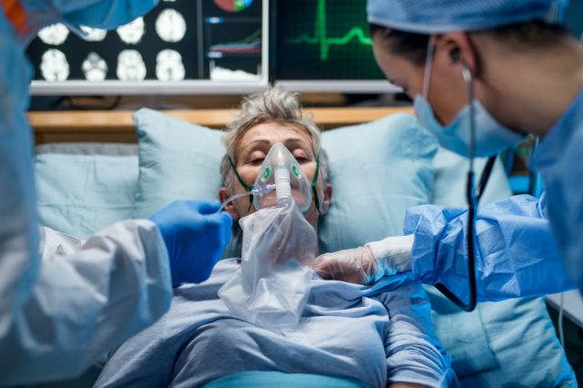 Infected patient in quarantine lying in bed in hospital, coronavirus concept.