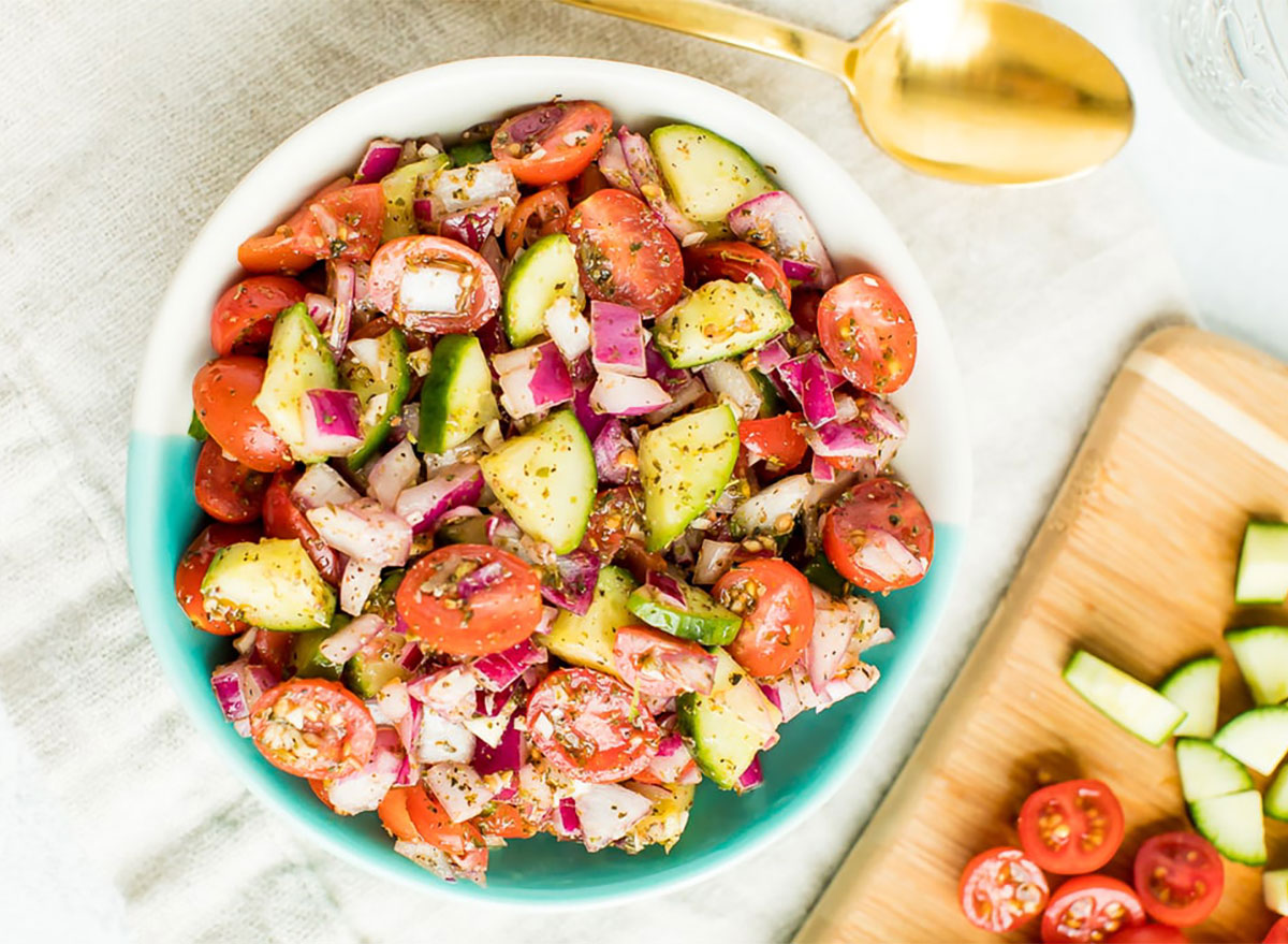 cucumber tomato salad in blue bowl