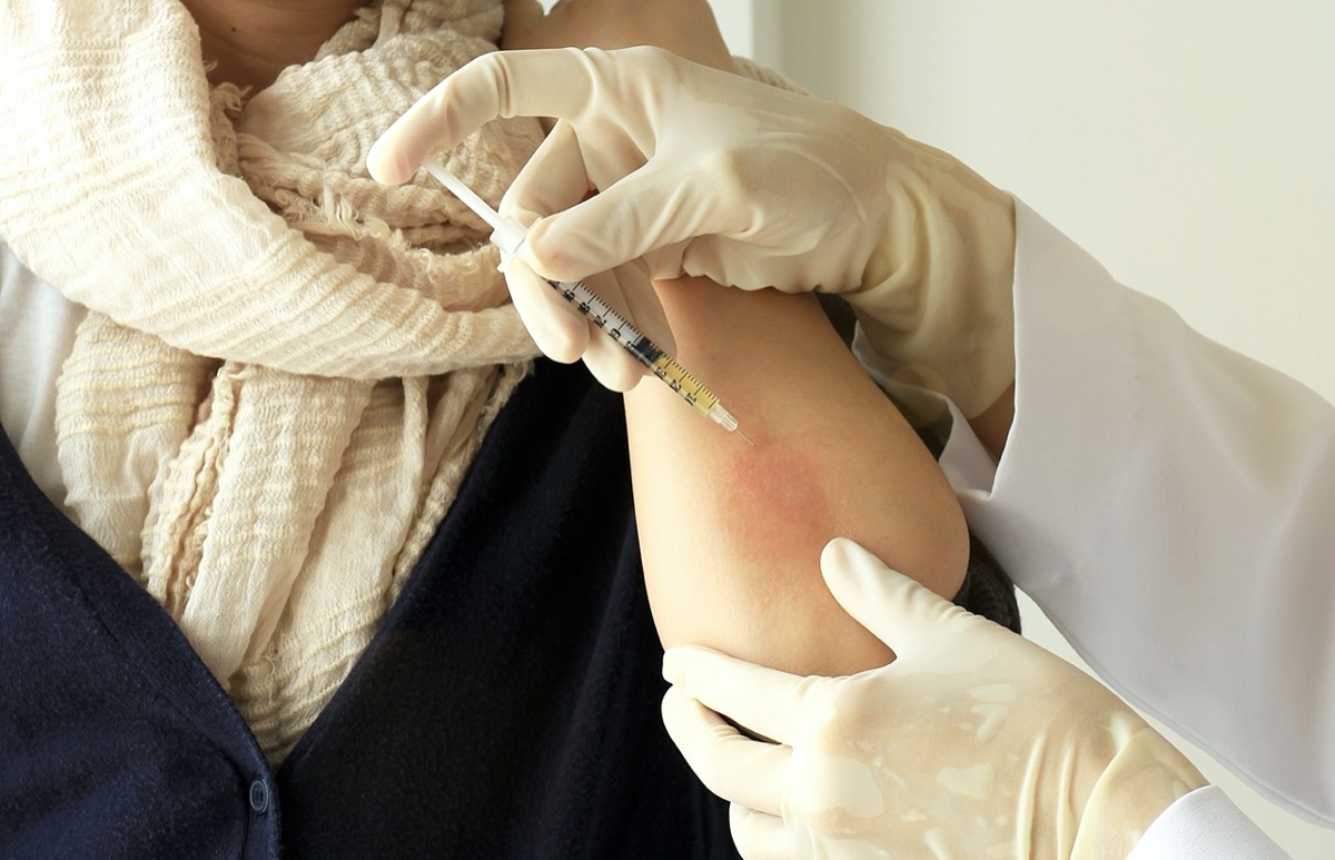 octor injecting at patient's arm