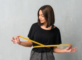 Young sport woman with tape measure