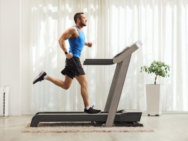 man running on a treadmill at home