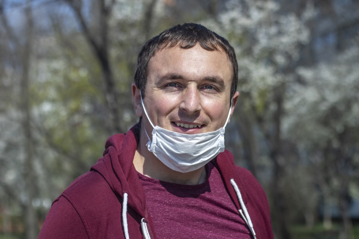 man wearing a surgical face mask on his chin breaking face mask policy