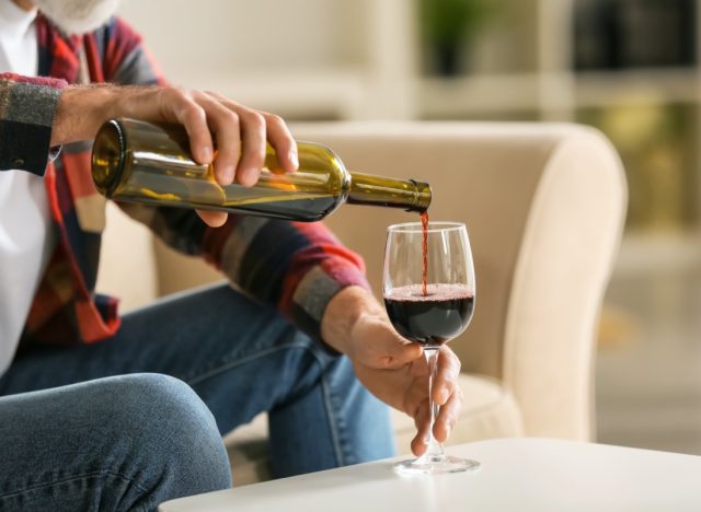 man pouring a glass of wine