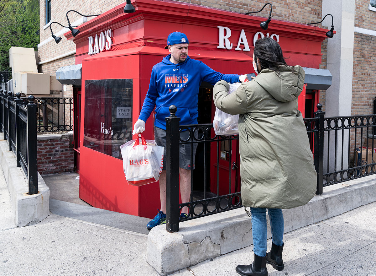 woman getting takeout from raos restaurant