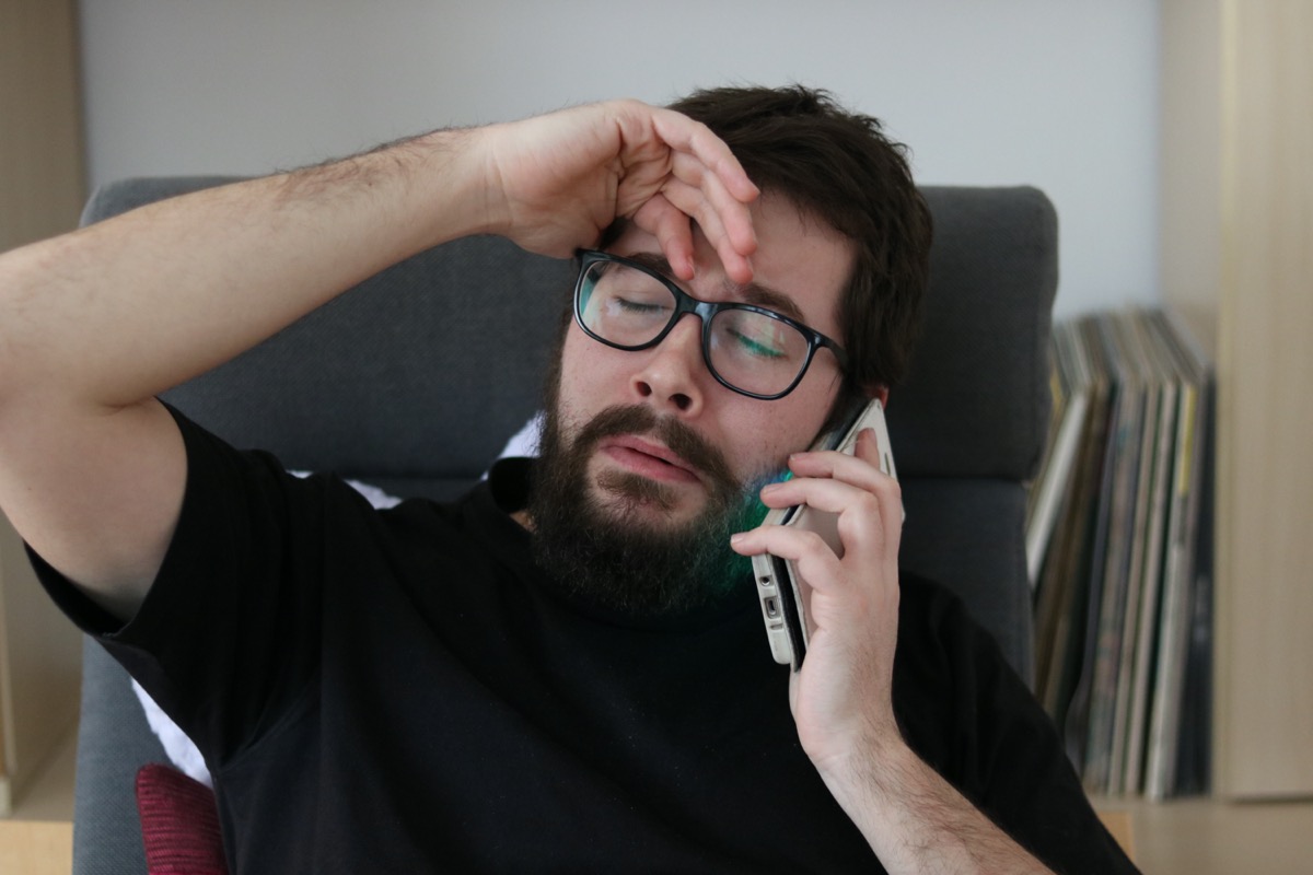 Depressed Man Crying while talking at the Phone
