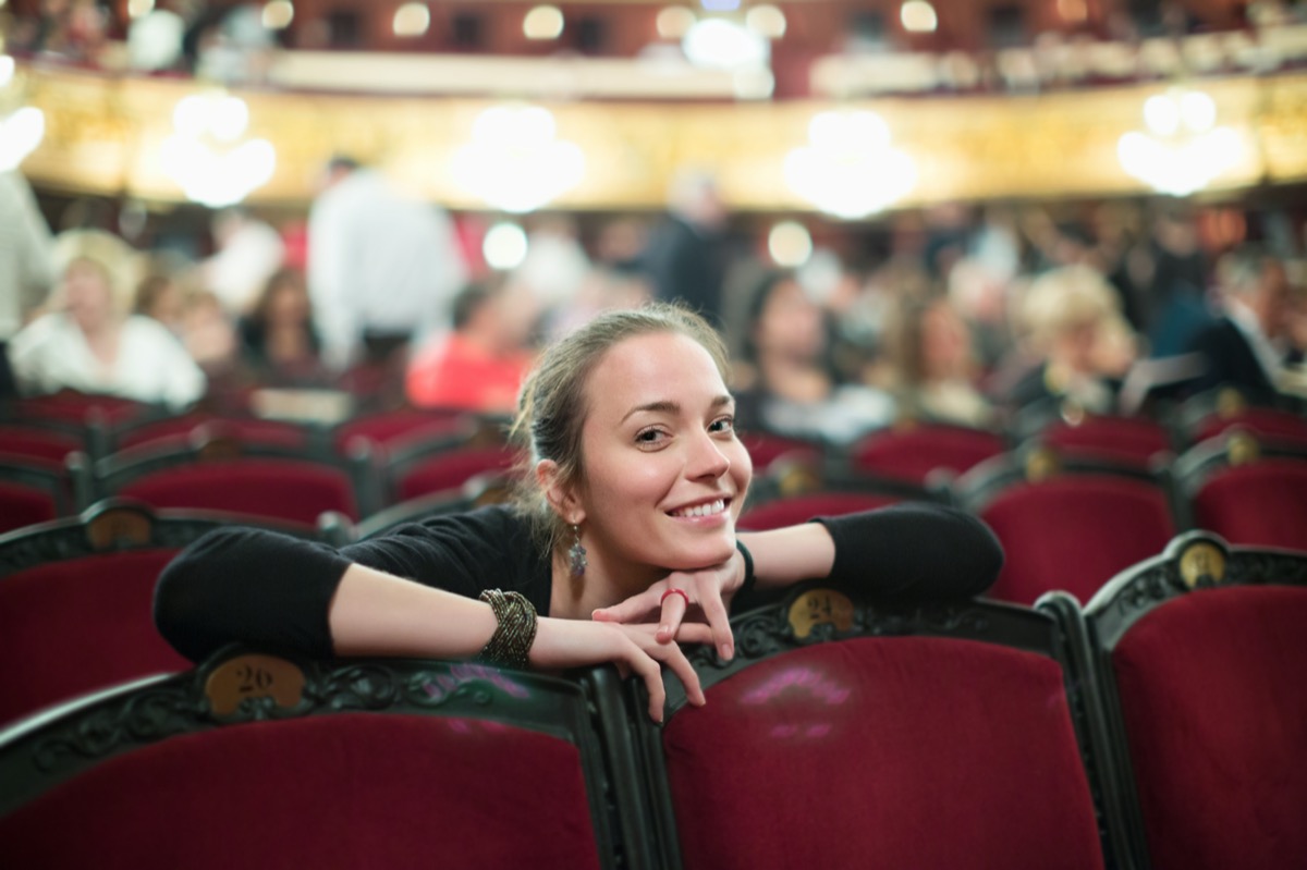 Portrait of smiling woman in auditorium of opera teatre