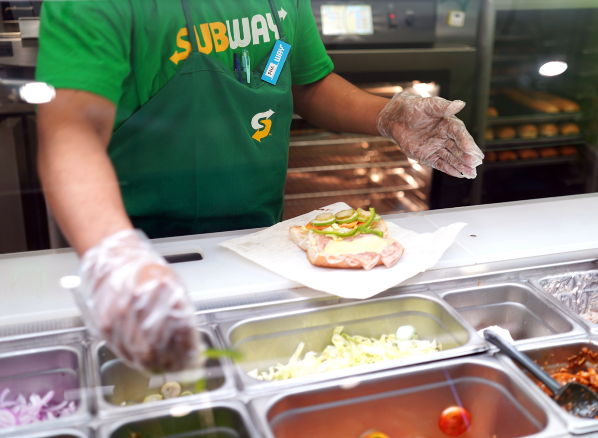 Subway sandwich artist making sub