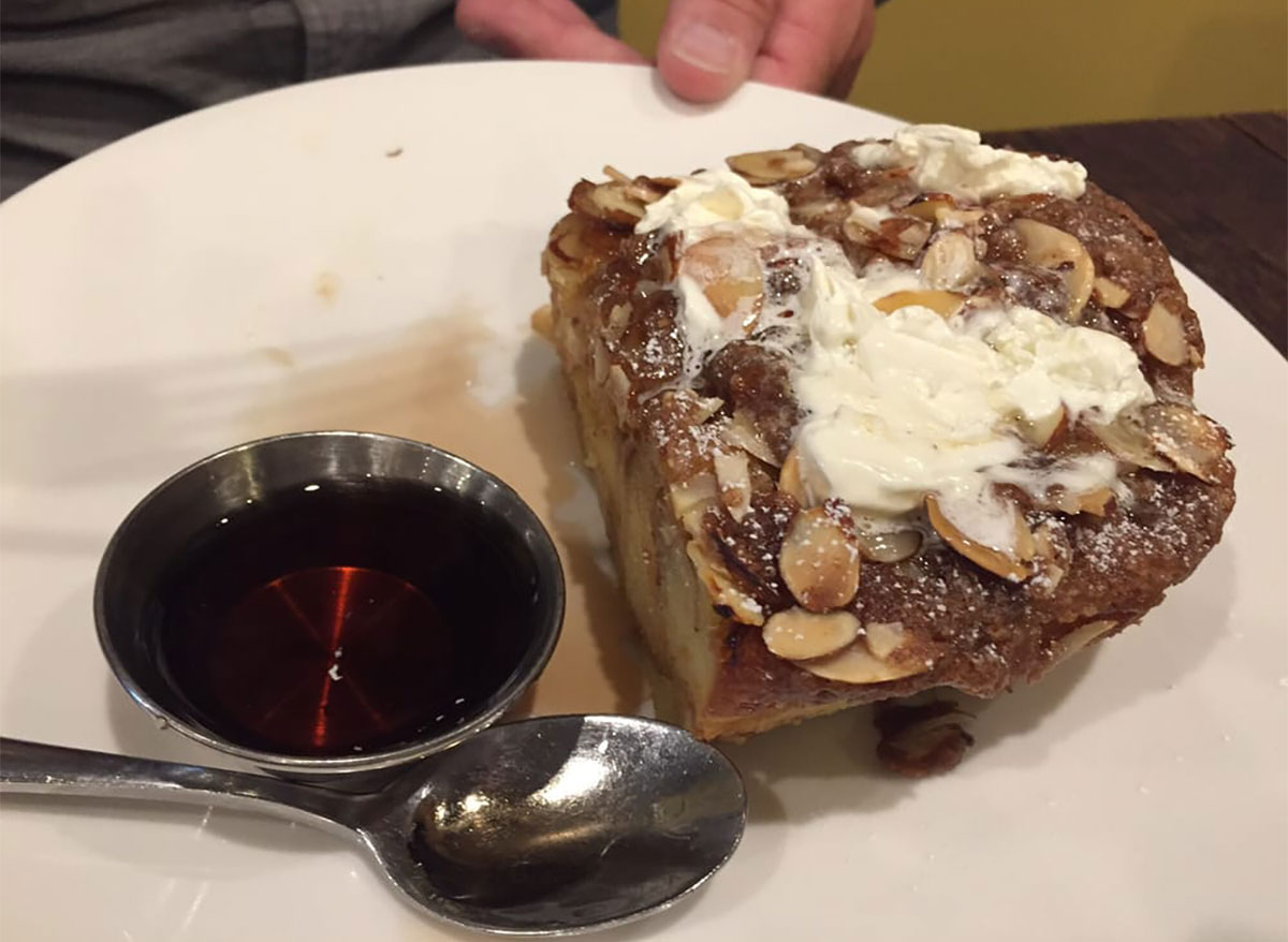 toasted almond french toast with syrup cup