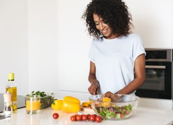 black woman cooking salad