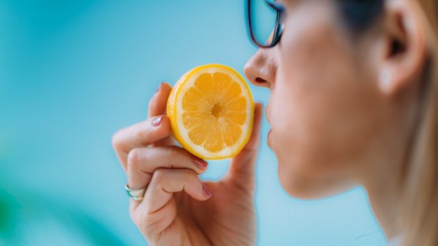 Woman Trying to Sense Smell of a Lemon
