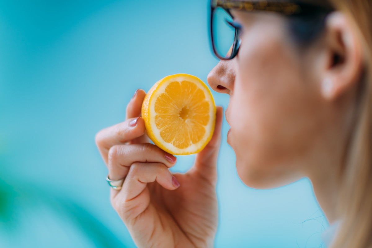 Woman Trying to Sense Smell of a Lemon