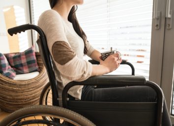 young disabled woman in wheelchair at home
