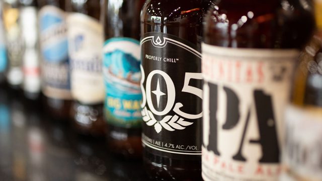 beer bottles lined up on bar