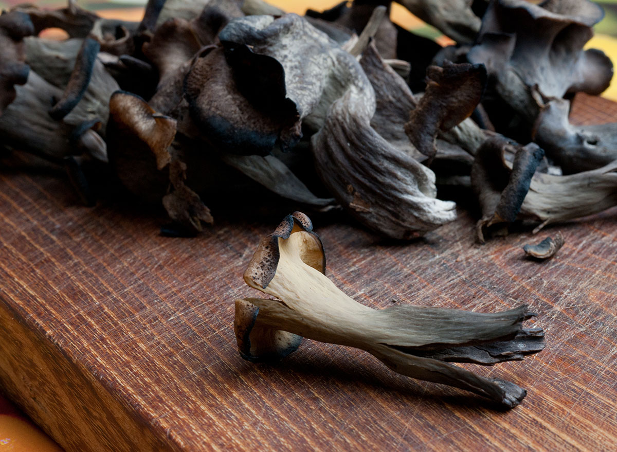 black trumpet mushrooms on wooden board