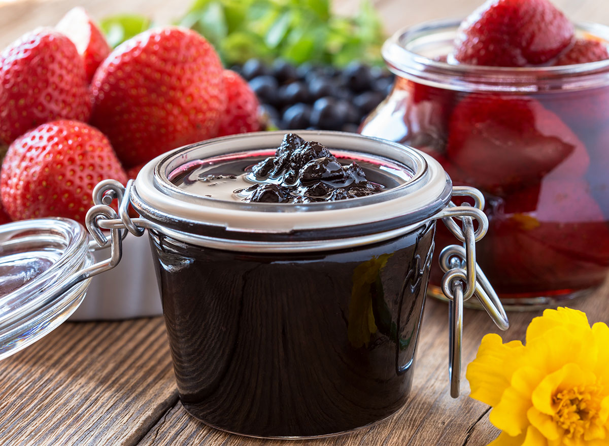 jar of blueberry jam compote with fresh strawberries