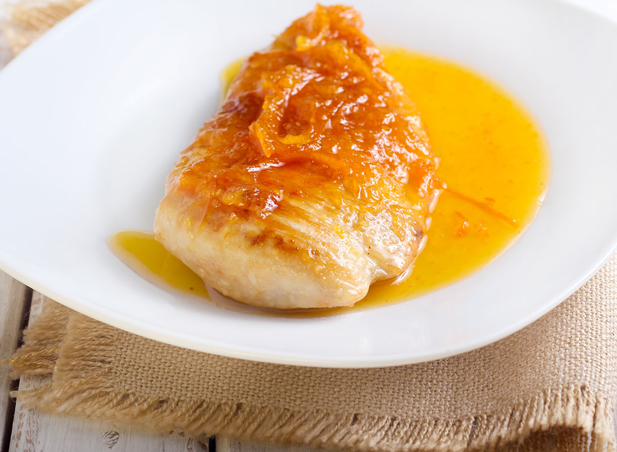 citrus glazed chicken breast on white plate