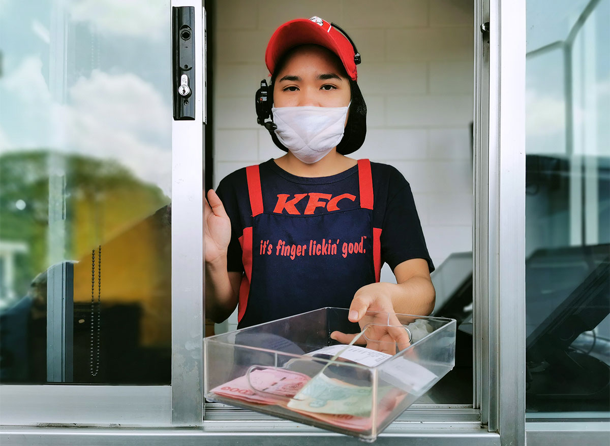 kfc employee at drive thru wearing face mask