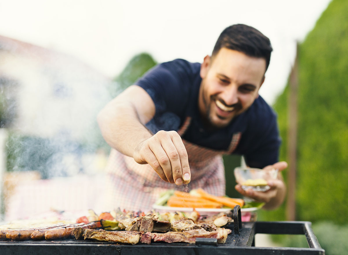 man seasoning meat