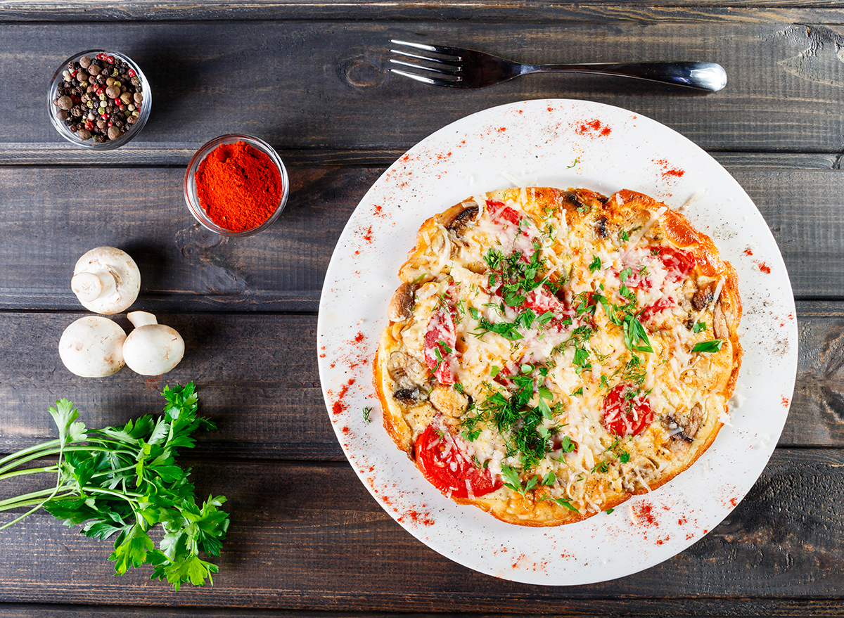 pizza omelet on a white plate with spices